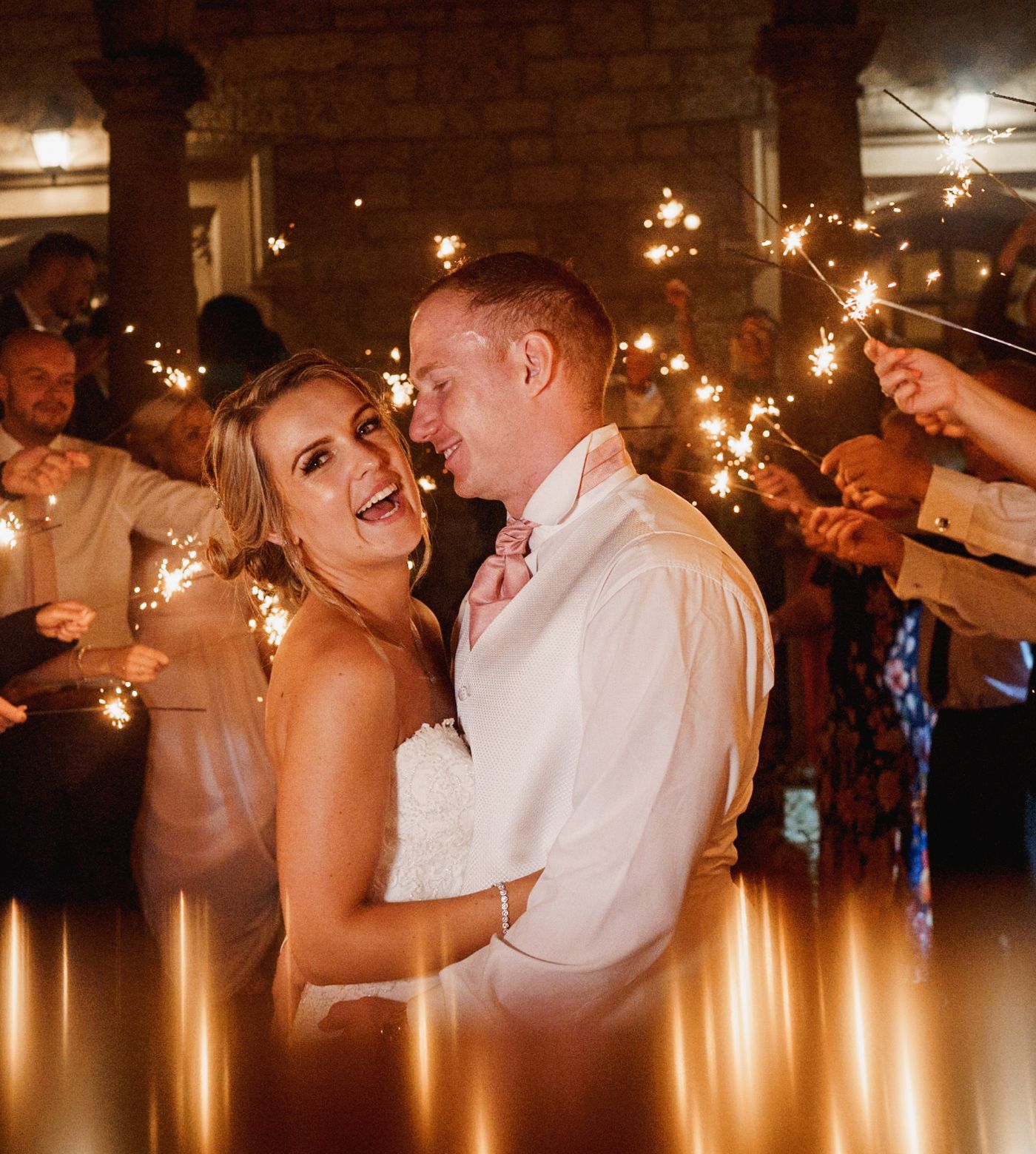 Married couple celebrating wedding with sparklers 