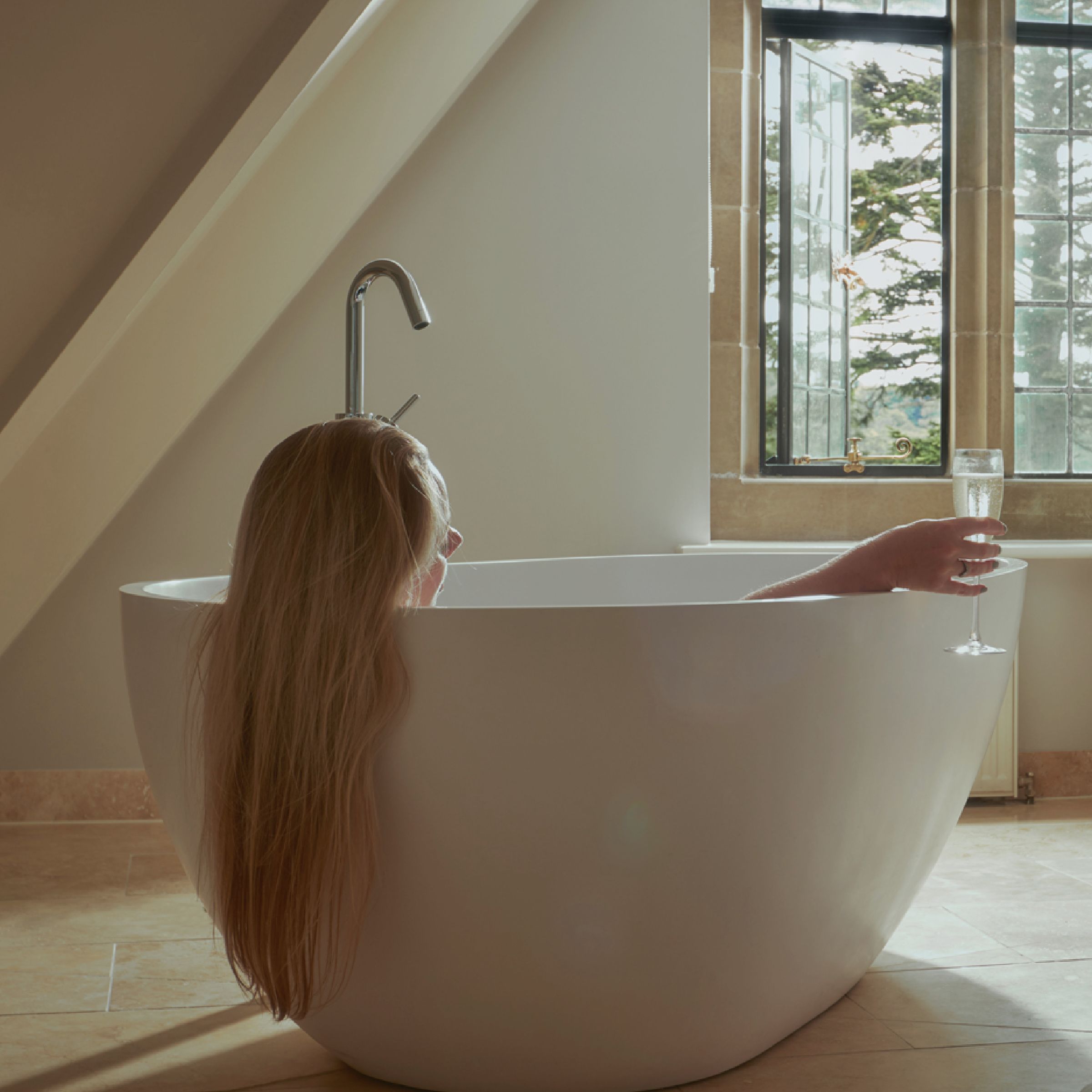 Woman relaxing in Bovey Castle Dartmoor bath 