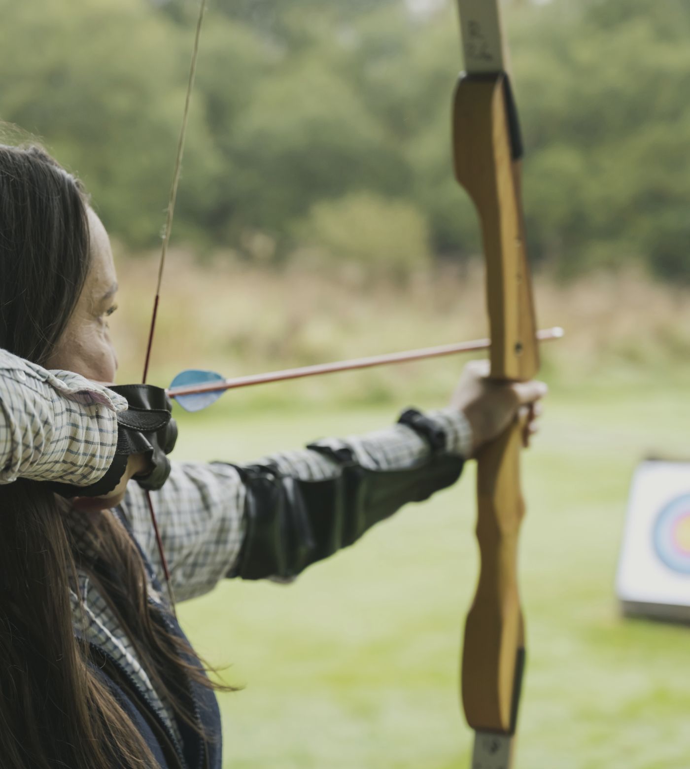 woman taking aim during archery 