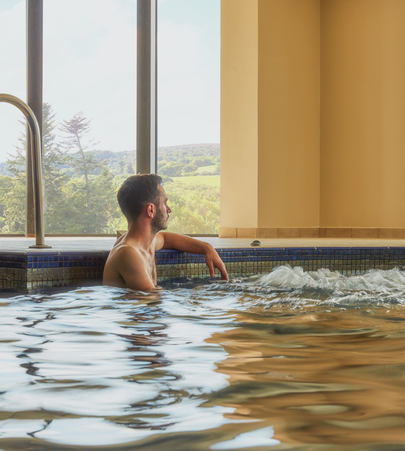 Bovey Castle Spa - man relaxing in pool with bubbles 