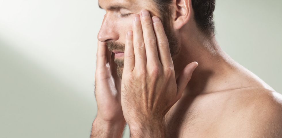 Man rubbing his face peacefully during spa break in Devon 