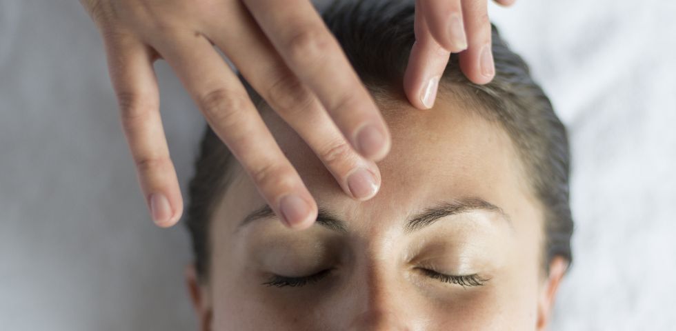 woman receiving forehead massage 