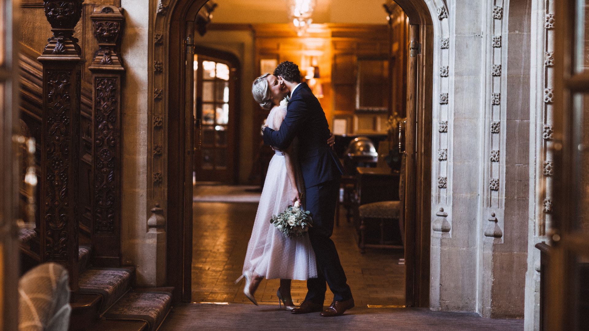 Married couple embracing at arched doorway